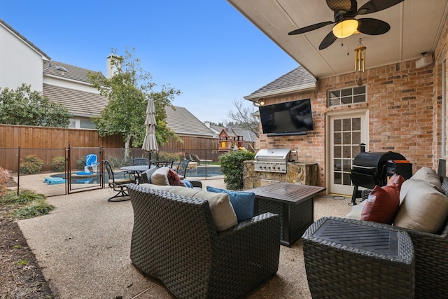 view of patio with exterior kitchen, a fenced in pool, a fenced backyard, and a grill