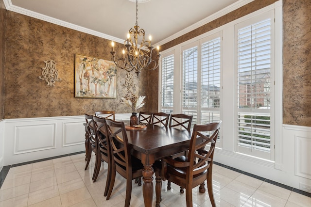 dining space with wallpapered walls, light tile patterned floors, ornamental molding, and a wainscoted wall