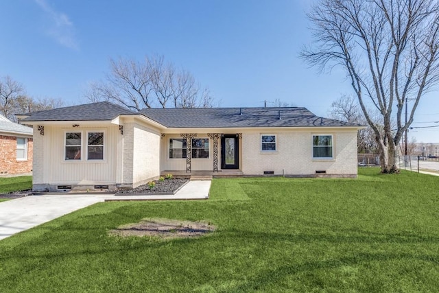 view of front facade with brick siding, a front yard, and fence