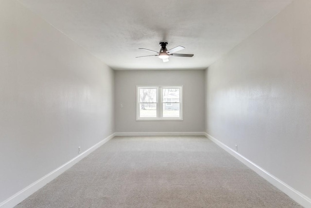 empty room featuring carpet floors, baseboards, and a ceiling fan