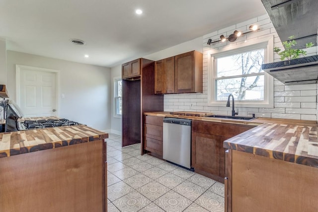 kitchen featuring butcher block counters, a sink, visible vents, decorative backsplash, and dishwasher