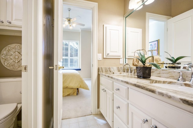 bathroom featuring double vanity, a sink, toilet, and ensuite bathroom