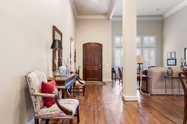 entryway featuring a towering ceiling, crown molding, and dark wood-type flooring