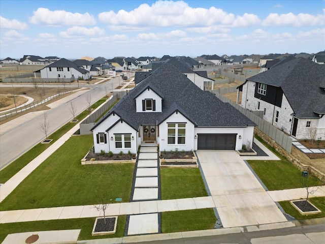 view of front of home featuring roof with shingles, a residential view, fence, and a front yard