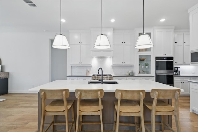 2412 Strolling Way, Argyle, TX 76226 - kitchen with decorative backsplash, white cabinetry, baseboards, recessed lighting, and a sink