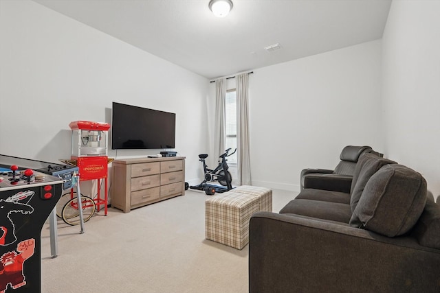 living area featuring light carpet, visible vents, and baseboards