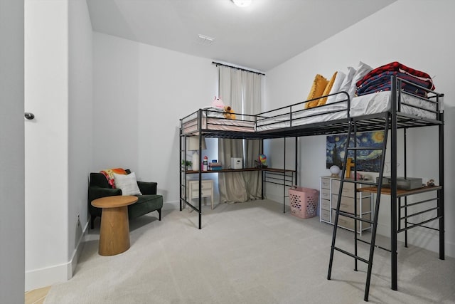 bedroom with carpet floors and baseboards