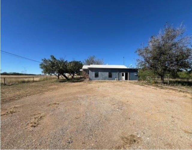 view of front of property with a rural view