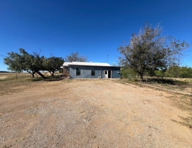 view of front of house with a rural view