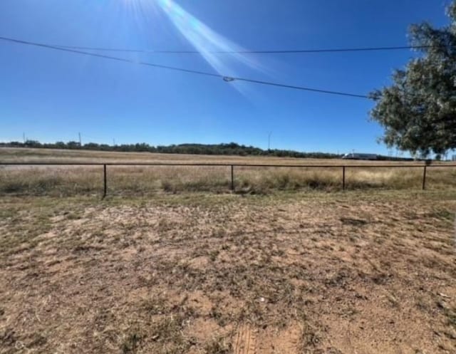 view of yard featuring a rural view and fence