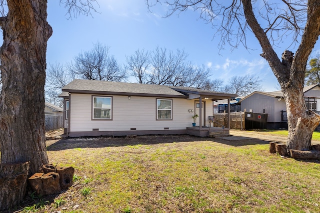 view of front of home featuring crawl space, roof with shingles, fence, and a front yard