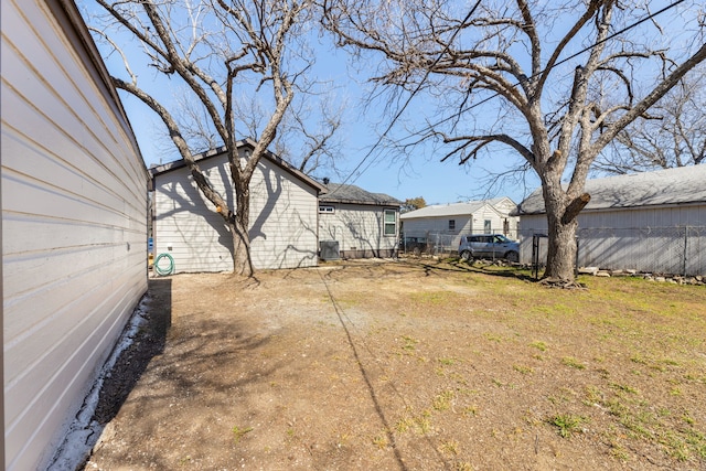 view of yard featuring cooling unit, fence, and driveway