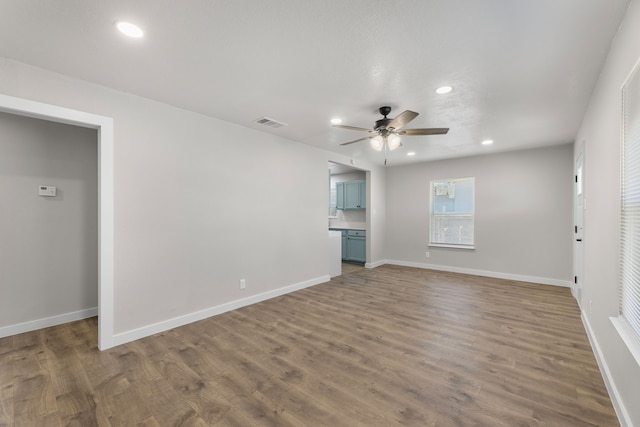 unfurnished bedroom with recessed lighting, wood finished floors, and baseboards