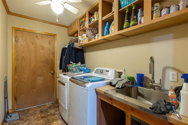 laundry area with laundry area, ornamental molding, stone finish flooring, washer and dryer, and a sink