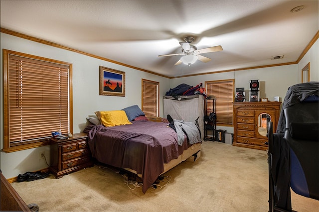 bedroom featuring light carpet, visible vents, a ceiling fan, a closet, and crown molding