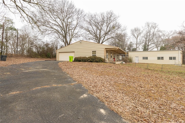 view of front of house with a garage and an outdoor structure