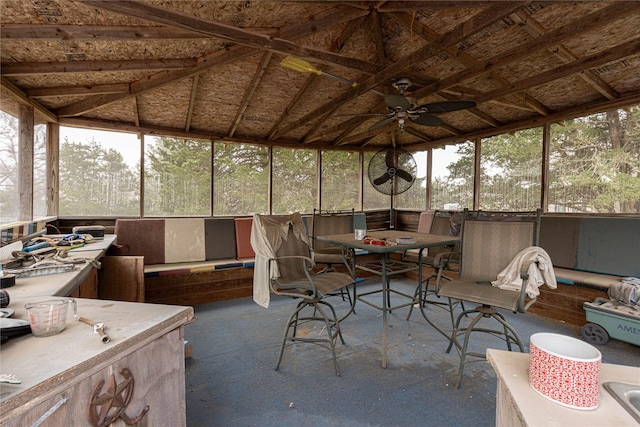 sunroom featuring lofted ceiling and a ceiling fan