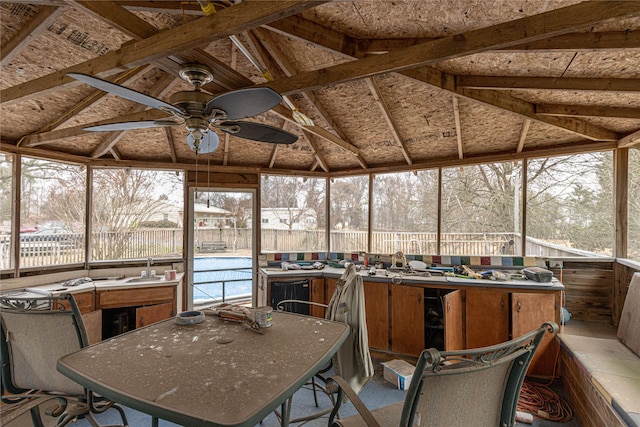 sunroom / solarium featuring lofted ceiling and a ceiling fan