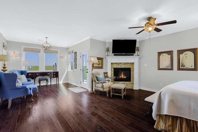 bedroom with baseboards, ornamental molding, dark wood-type flooring, and a stone fireplace