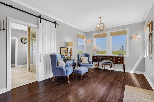 sitting room with a barn door, crown molding, a chandelier, and wood finished floors