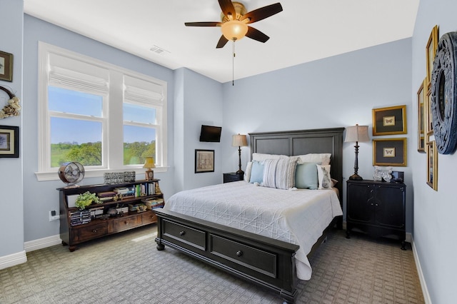 carpeted bedroom with a ceiling fan, visible vents, and baseboards