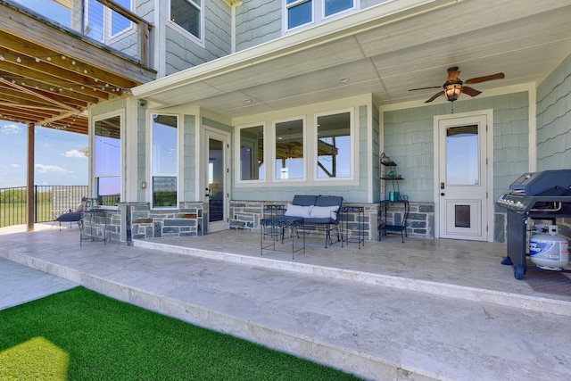 view of patio with ceiling fan, a grill, fence, and an outdoor living space