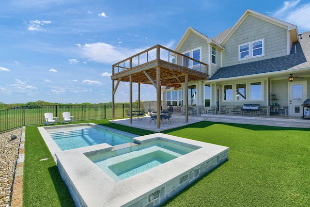 rear view of house with a patio, a fenced backyard, a pool with connected hot tub, a yard, and roof with shingles