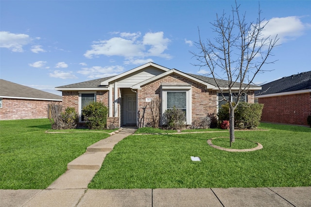 single story home featuring brick siding and a front yard