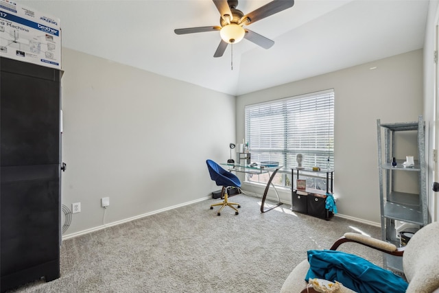 carpeted home office with lofted ceiling, baseboards, and a ceiling fan