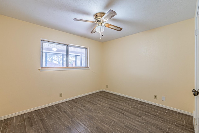 unfurnished room featuring a textured ceiling, dark wood finished floors, a ceiling fan, and baseboards