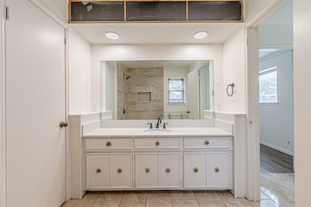 full bathroom featuring walk in shower and vanity