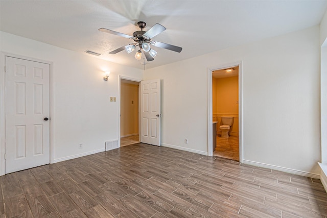 unfurnished bedroom with baseboards, visible vents, and wood finished floors