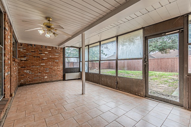 unfurnished sunroom featuring ceiling fan