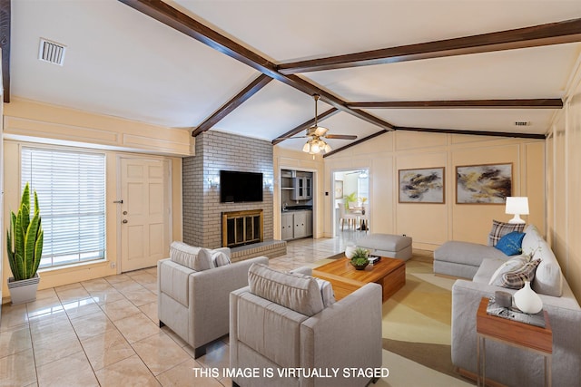 living room featuring vaulted ceiling with beams, visible vents, a fireplace, and a ceiling fan