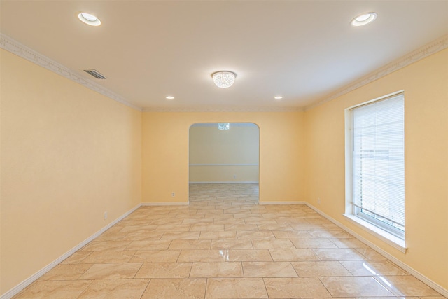 unfurnished room featuring ornamental molding, arched walkways, visible vents, and baseboards