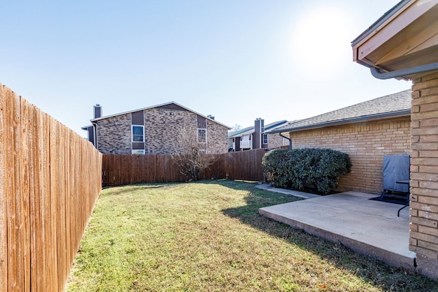 view of yard with a fenced backyard and a patio