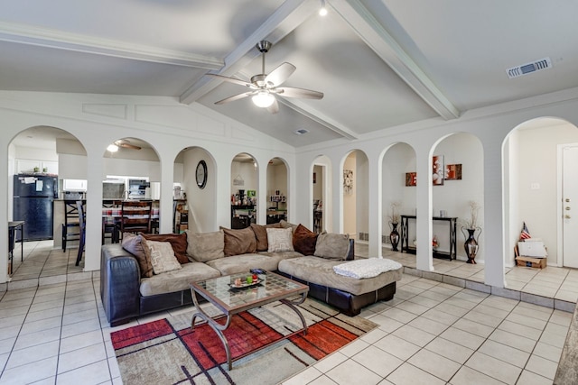 living room with vaulted ceiling with beams, light tile patterned floors, visible vents, and a ceiling fan