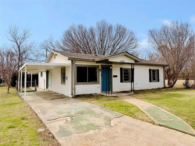 view of front facade with a carport, a front yard, and driveway