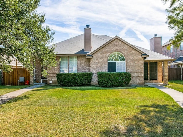 single story home with a front lawn, a chimney, and fence