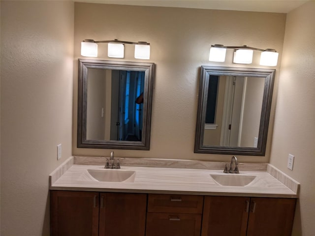 bathroom with a sink and double vanity