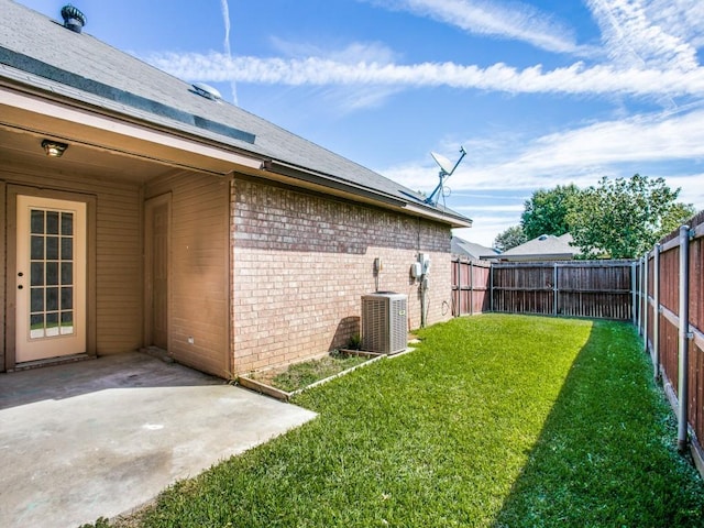 view of yard featuring central air condition unit, a patio area, and a fenced backyard