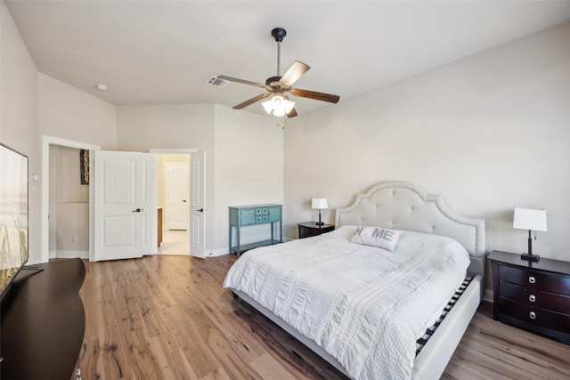 bedroom with light wood-type flooring, baseboards, visible vents, and ceiling fan