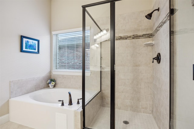 bathroom with a stall shower and a garden tub