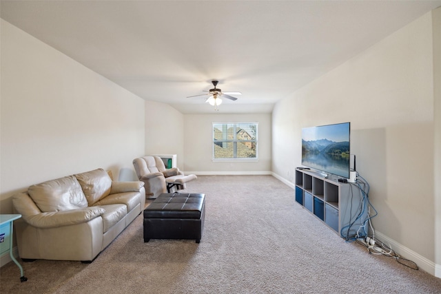 carpeted living area with a ceiling fan and baseboards