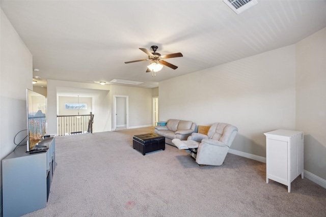 carpeted living room with a ceiling fan, visible vents, and baseboards