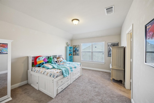 bedroom with baseboards, visible vents, and light colored carpet