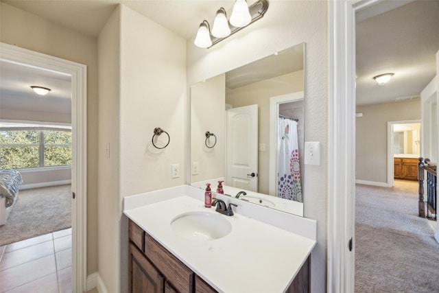 full bath with tile patterned flooring, vanity, and baseboards