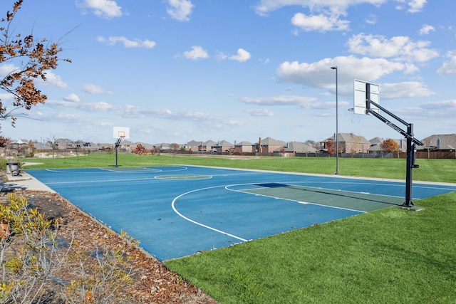 view of basketball court with community basketball court, a residential view, and a lawn