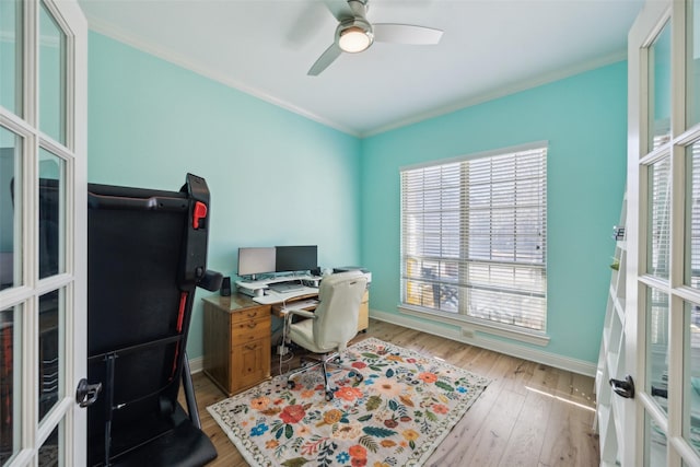 home office with light wood-type flooring, baseboards, ornamental molding, and french doors