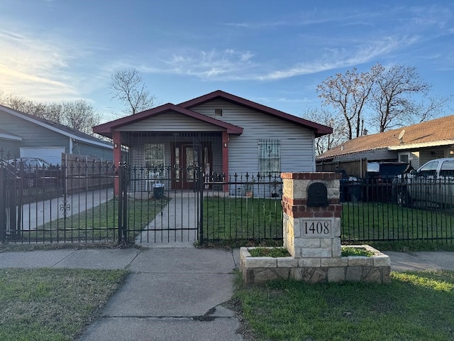 bungalow featuring a fenced front yard and a gate